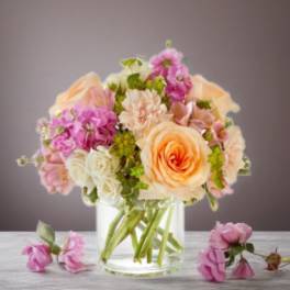 Peach and pink flower bouquet in a clear glass vase