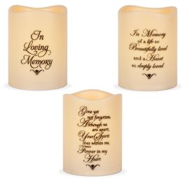 Three memorial candles with remembrance text