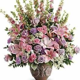 Pink and lavender floral arrangement in a decorative vase