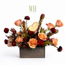 Peach and burgundy floral arrangement in a wooden box
