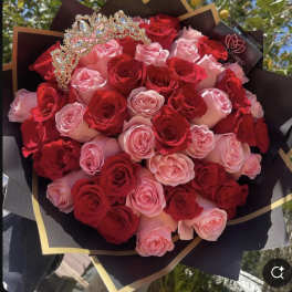 Bouquet of red and pink roses with a jeweled crown topper