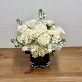 White rose bouquet in a dark glass vase