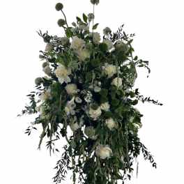 Large white and green floral spray with cascading greenery