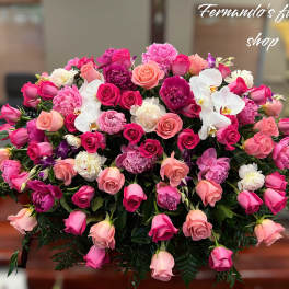 Large pink and white rose and peony casket spray with white orchids