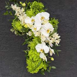 Green and white floral standing spray with orchids and chrysanthemums