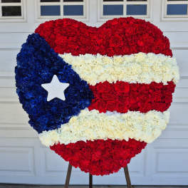 Heart-shaped floral display in red, white, and blue with a star accent