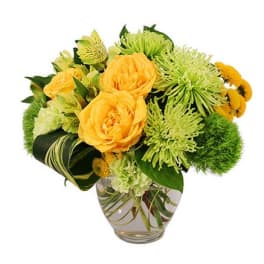 Yellow roses and green chrysanthemums in a clear glass vase