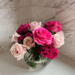 Bouquet of pink and white roses in a clear glass vase