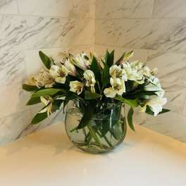 White alstroemeria bouquet in a clear glass vase