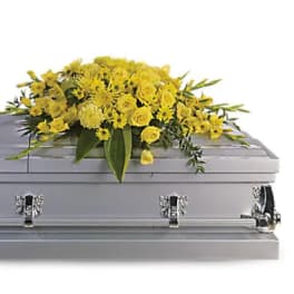 Yellow floral spray on a silver casket