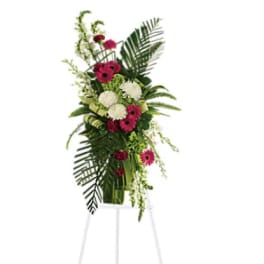 Tall standing floral spray with pink and white blooms on an easel