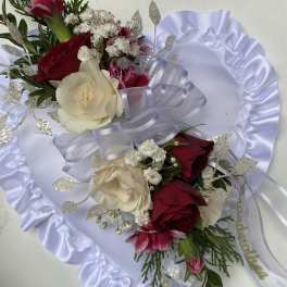 Two rose bouquets with white ribbon and satin backing