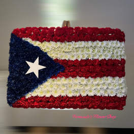 Rectangular floral arrangement styled as a red, white, and blue flag with a single white star.