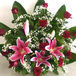 Bouquet of red roses and pink lilies with white baby's breath