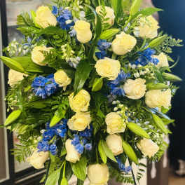 Bouquet of cream roses and blue flowers with lily buds