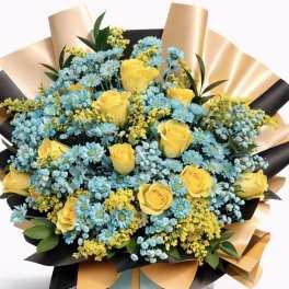 Bouquet of yellow roses and blue daisies wrapped in black and gold paper