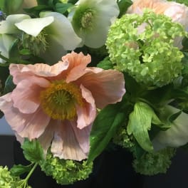 Bouquet of pale pink and white flowers with bright green blooms