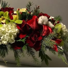 Red roses and white flowers arranged in a rectangular container
