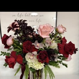 Bouquet of red and pink roses in a clear glass vase