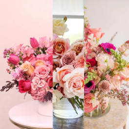 Three pink and peach floral arrangements with roses and tulips