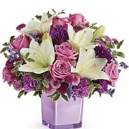 Pink roses and white lilies in a lavender vase