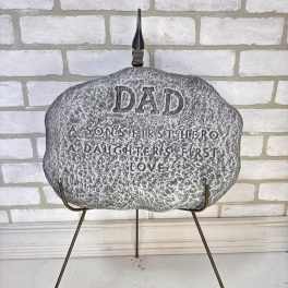 Memorial stone on a metal stand with engraved text for Dad