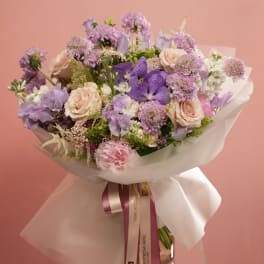 Lavender and blush bouquet wrapped in white paper