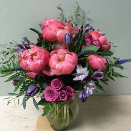 Pink and purple mixed bouquet in a clear glass vase