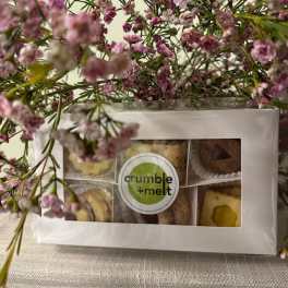 Pink baby's breath around a boxed assortment of treats