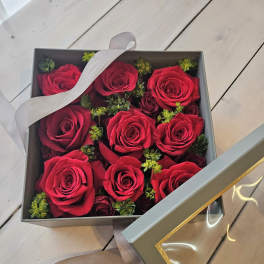 Box of red roses with a ribbon-tied lid