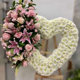 Heart-shaped floral wreath with pink roses and white chrysanthemums