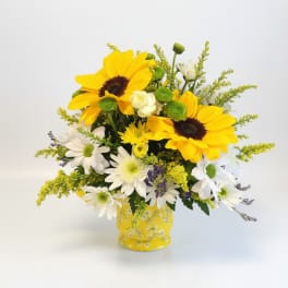 Yellow sunflowers and white daisies in a yellow vase