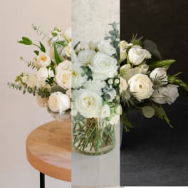 White rose bouquet in a clear glass vase with eucalyptus