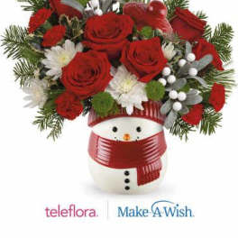Red roses and white flowers arranged in a snowman container with a red scarf