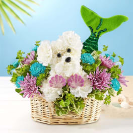 Basket arrangement with a white flower dog and colorful blooms