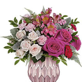 Pink and white rose bouquet in a pink textured vase