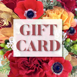 Gift card over a colorful bouquet of red, yellow, and white flowers
