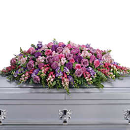 Funeral Casket adorned with Purple and Pink Roses