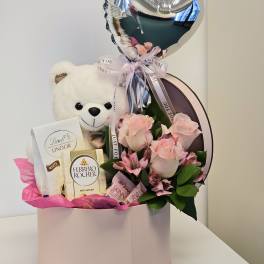 Beautiful arrangement with bear and chocolates