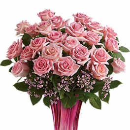 Pink roses arranged in a tall magenta vase