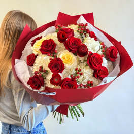 Large bouquet of red and cream roses wrapped in red paper