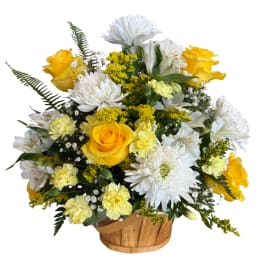 Yellow roses and white daisies in a wooden basket