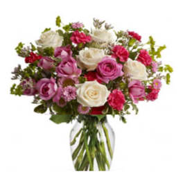 Bouquet of pink and white roses in a clear glass vase