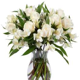 Arrangement of white roses and alstroemeria in a clear glass vase