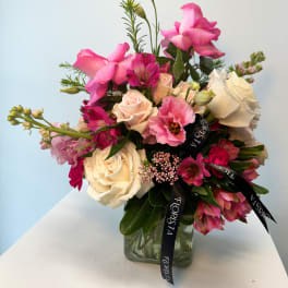 Pink and cream rose bouquet in a glass vase