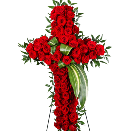 Standing cross of red roses with striped green leaves on an easel