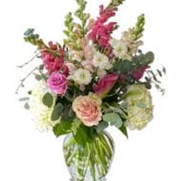 Mixed pink and white flowers in a clear glass vase