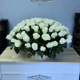 Large bouquet of white roses in a white basket