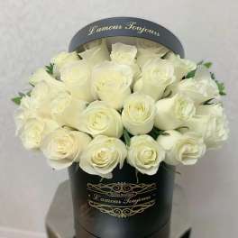 White roses arranged in a black round box