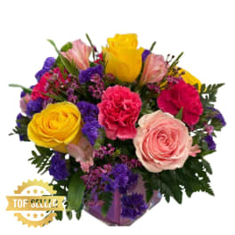 Mixed bouquet with yellow and pink roses, carnations, and purple filler flowers